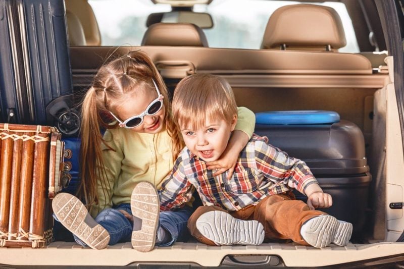 Kids sitting in the back seat of a car
