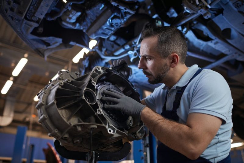 Nissan tech servicing a vehicle