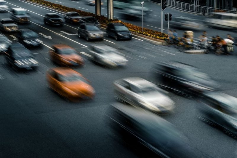 A busy road with cars in multiple lanes.