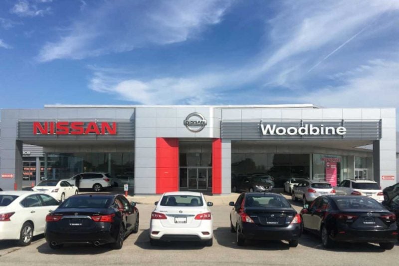 Cars parked in front of the Woodbine Nissan car dealership.