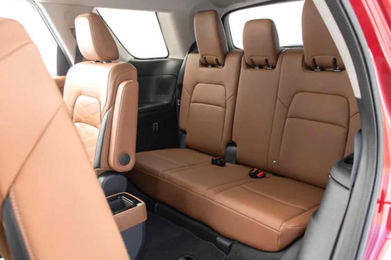 The second row seats in a SUV are turned down to show the third row in the 2024 Nissan Pathfinder.