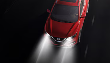 The Automatic High Beams safety feature on a red Nissan vehicle.