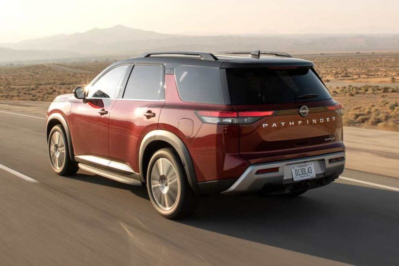 You can see the back of the red Pathfinder SUV as it drives away on a sunny highway.