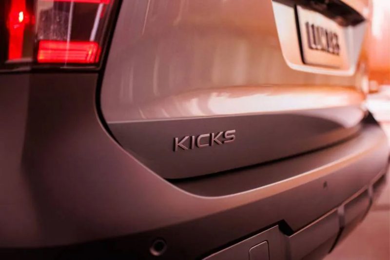 The nameplate 'Kicks' shown on the back of a grey Nissan SUV.
