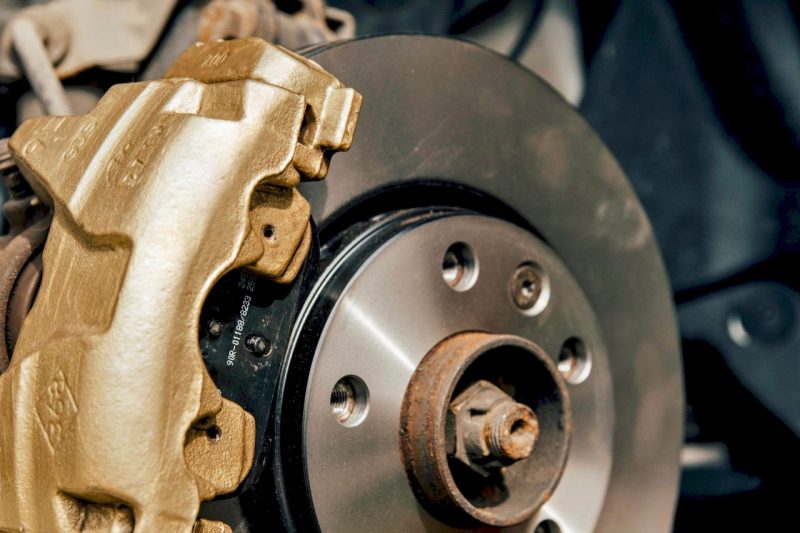 A close-up shot of a brake system with brake pads and rotors.