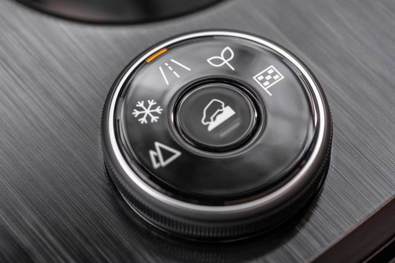 A close-up show of a drive mode dial in a Nissan Rogue.