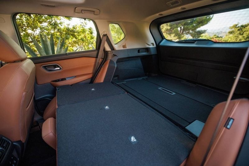 The rear cargo area of a Nissan SUV with seats down, showing its large cargo capacity.