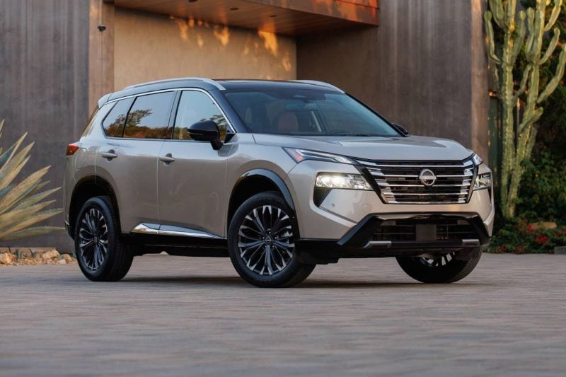 The all-new 2025 Nissan Rogue SUV is posed in front of a modern home.