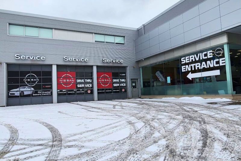 The exterior of the Woodbine Nissan Service Department, with its service drive-thru doors.