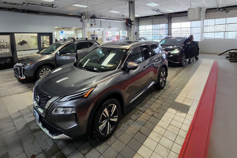Vehicles in the Woodbine Nissan service drive-thru, waiting for their owners to collect them after appointments.