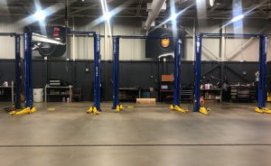 Interior of Nissan of Windsor service facility showing 3 available hoists.