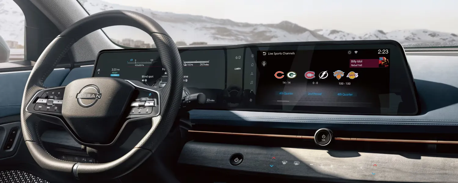2026 Nissan Ariya cabin with panoramic dual screen and driver assistance technologies.