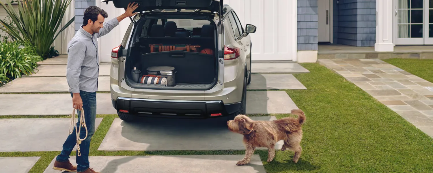 Open trunk of the 2026 Nissan Rogue in front of a home to conclude the specs article.