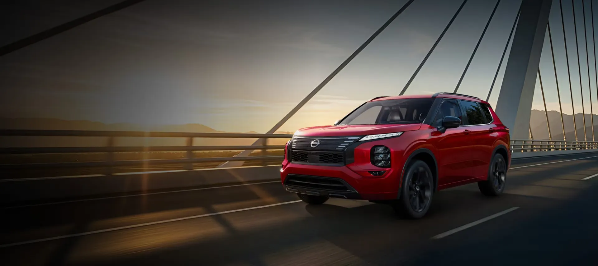 Nissan Rogue hybride rechargeable 2026 rouge roulant sur un pont.