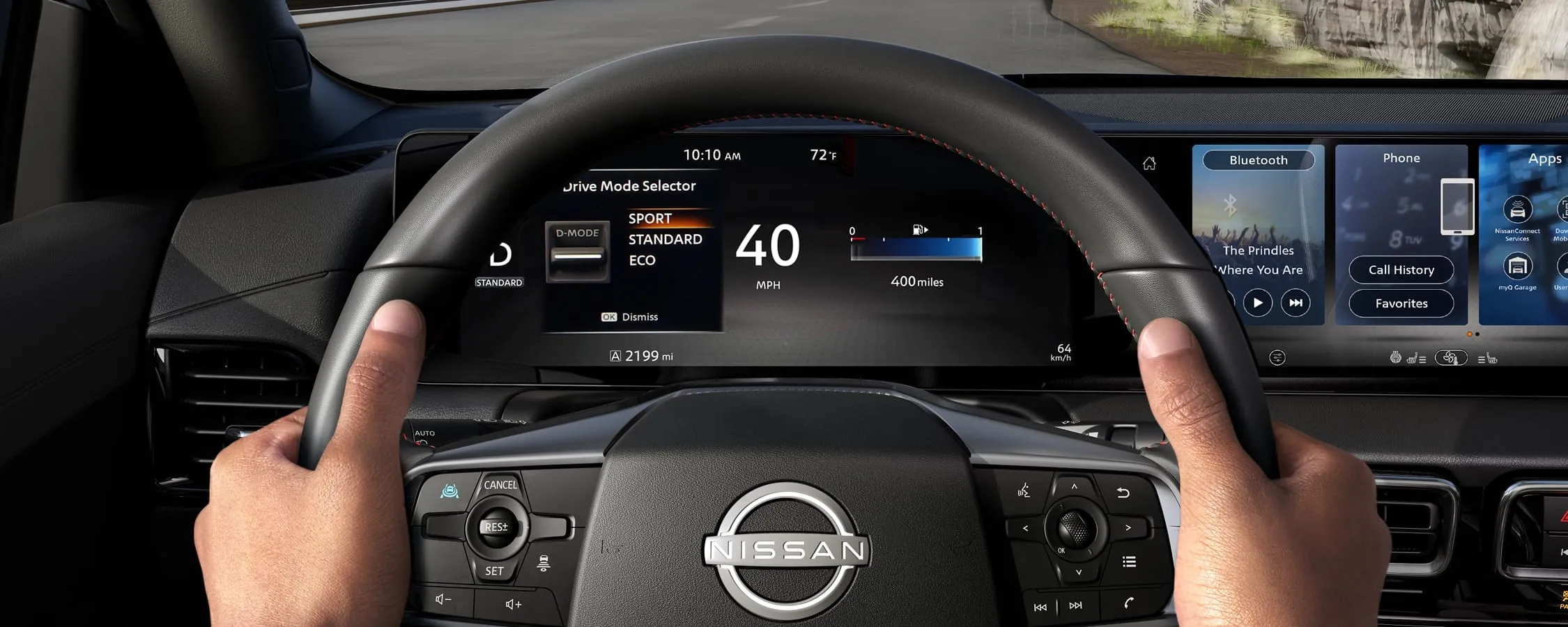 Volant et écrans numériques de la Nissan Sentra 2026 en conduite.