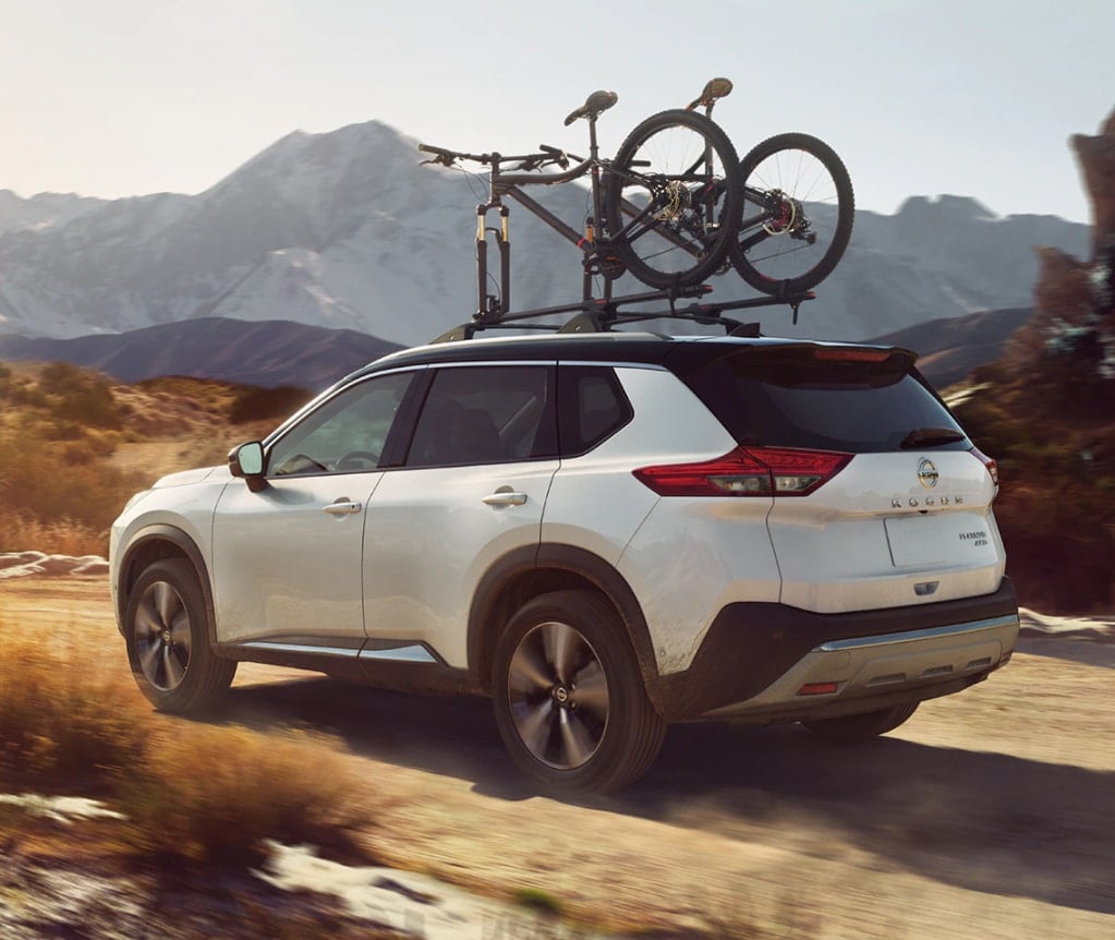 White 2021 Nissan Rogue Driving Off Road With Bicycle on Bike Rack on Roof - Stratford, Ontario