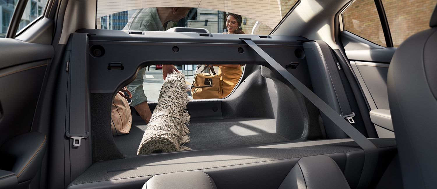 2022 Nissan Sentra displaying people putting a rug into the cargo space 